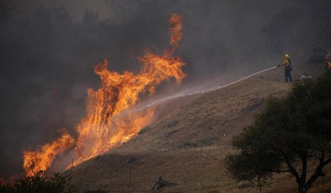 Fire-fighters battle walls of flames to protect homes during the second day of the Springs Fire in the mountain areas of Ventura County, Cal Fire-fighters battle walls of flames to protect homes during the second day of the Springs Fire in the mountain areas of Ventura County, Cal