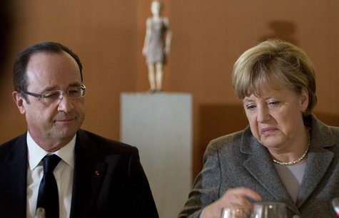 German Chancellor Angela Merkel (R) and French President Francois Hollande arrive for a dinner with representatives of the European Round Ta German Chancellor Angela Merkel (R) and French President Francois Hollande arrive for a dinner with representatives of the European Round Ta
