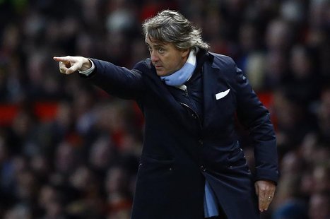 Manchester City's coach Roberto Mancini gestures during their English Premier League soccer match against Manchester United in Manchester, n Manchester City's coach Roberto Mancini gestures during their English Premier League soccer match against Manchester United in Manchester, n