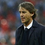 Manchester City's manager Roberto Mancini reacts in the rain after his team was defeated by Wigan Athletic in their FA Cup final soccer matc Manchester City's manager Roberto Mancini reacts in the rain after his team was defeated by Wigan Athletic in their FA Cup final soccer matc