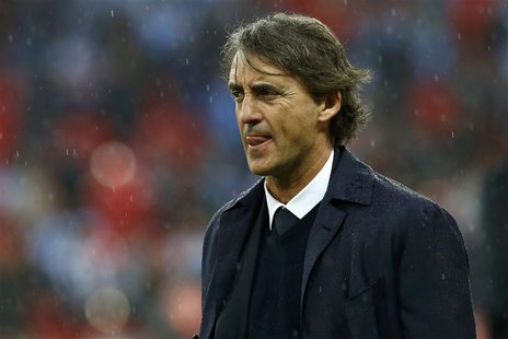 Manchester City's manager Roberto Mancini reacts in the rain after his team was defeated by Wigan Athletic in their FA Cup final soccer matc Manchester City's manager Roberto Mancini reacts in the rain after his team was defeated by Wigan Athletic in their FA Cup final soccer matc