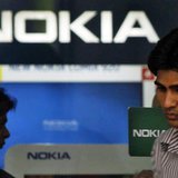 A customer speaks on his mobile phone as he comes out of a Nokia showroom in New Delhi March 28, 2013. REUTERS/Mansi Thapliyal A customer speaks on his mobile phone as he comes out of a Nokia showroom in New Delhi March 28, 2013. REUTERS/Mansi Thapliyal