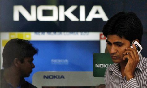 A customer speaks on his mobile phone as he comes out of a Nokia showroom in New Delhi March 28, 2013. REUTERS/Mansi Thapliyal A customer speaks on his mobile phone as he comes out of a Nokia showroom in New Delhi March 28, 2013. REUTERS/Mansi Thapliyal