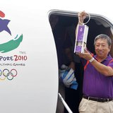 Chairman of the Singapore Youth Olympic Committee Ng Ser Miang arrives with a safety lantern containing the Youth Olympic flame at Changi Ai