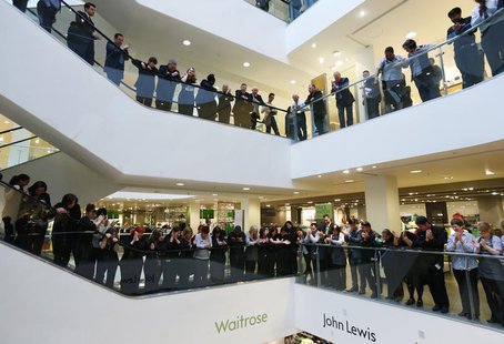 Workers, known as partners at the John Lewis Partnership, celebrate after the announcement of their annual profit related bonus, at their fl Workers, known as partners at the John Lewis Partnership, celebrate after the announcement of their annual profit related bonus, at their fl