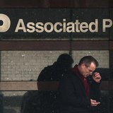 A man looks down at his smartphone as he walks past the offices of the Associated Press in Manhattan, New York May 13, 2013. REUTERS/Adrees A man looks down at his smartphone as he walks past the offices of the Associated Press in Manhattan, New York May 13, 2013. REUTERS/Adrees