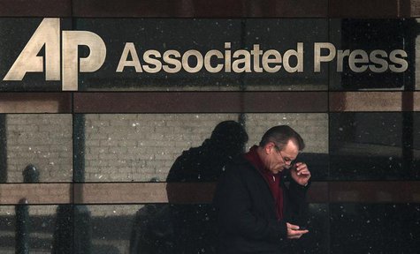 A man looks down at his smartphone as he walks past the offices of the Associated Press in Manhattan, New York May 13, 2013. REUTERS/Adrees A man looks down at his smartphone as he walks past the offices of the Associated Press in Manhattan, New York May 13, 2013. REUTERS/Adrees