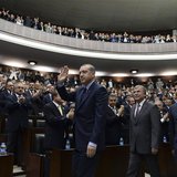 Turkey's Prime Minister Tayyip Erdogan (C) greets members of parliament from his ruling AK Party (AKP) during a meeting at the Turkish parli Turkey's Prime Minister Tayyip Erdogan (C) greets members of parliament from his ruling AK Party (AKP) during a meeting at the Turkish parli