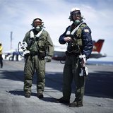 Northrop Grumman test pilots Bruce McFadden (L) and Dave Lorenz are pictured with their arm-mounted controllers after they successfully laun