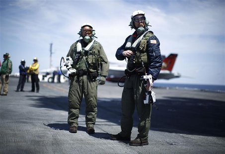 Northrop Grumman test pilots Bruce McFadden (L) and Dave Lorenz are pictured with their arm-mounted controllers after they successfully laun Northrop Grumman test pilots Bruce McFadden (L) and Dave Lorenz are pictured with their arm-mounted controllers after they successfully laun