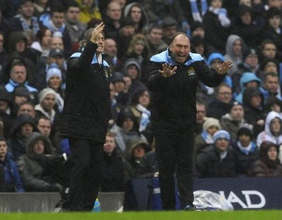Manchester City's manager Roberto Mancini (L) and his assistant David Platt instruct their team during their FA Cup soccer match against Man Manchester City's manager Roberto Mancini (L) and his assistant David Platt instruct their team during their FA Cup soccer match against Man