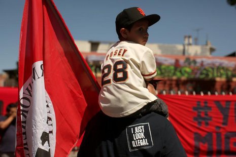 Dominic Ibarra sits on the shoulders of his grandfather Luis Ibarra during an immigration rally on May Day in the Mission District in San Fr Dominic Ibarra sits on the shoulders of his grandfather Luis Ibarra during an immigration rally on May Day in the Mission District in San Fr