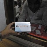 A man buys cancer drug Glivec for a relative who is suffering from cancer at a pharmacy in a government-run hospital in the western Indian c A man buys cancer drug Glivec for a relative who is suffering from cancer at a pharmacy in a government-run hospital in the western Indian c