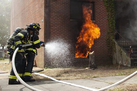 Firefighters put out a live fire during an experiment on Governors Island, in New York, July 3, 2012. REUTERS/Andrew Burton Firefighters put out a live fire during an experiment on Governors Island, in New York, July 3, 2012. REUTERS/Andrew Burton