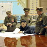 North Korean leader Kim Jong-un (C) presides over an urgent operation meeting on the Korean People's Army Strategic Rocket Force's performan