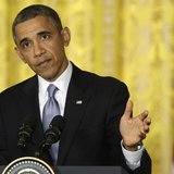 President Barack Obama pauses as he responds to a question during a news conference with Britain's Prime Minister David Cameron in the East 