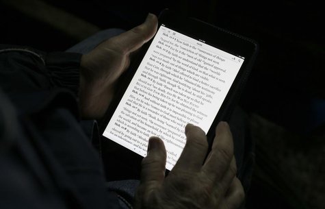 A man reads the bible from an iPad mini at the "Christ is the Answer International Ministries" group's camp near Florence February 2, 2013. A man reads the bible from an iPad mini at the "Christ is the Answer International Ministries" group's camp near Florence February 2, 2013.