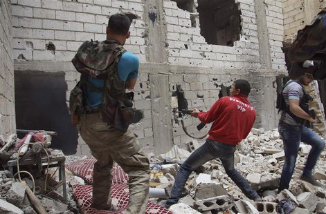 Free Syrian Army fighters return fire after what they say was during clashes with forces loyal to President Bashar al-Assad in Deir al-Zor M Free Syrian Army fighters return fire after what they say was during clashes with forces loyal to President Bashar al-Assad in Deir al-Zor M