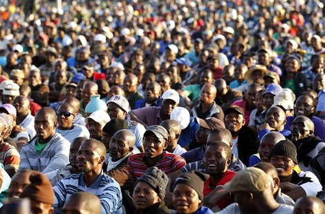 The mining community looks on as they are addressed by their leaders during a strike at Lonmin's Marikana platinum mine in Rustenburg, 100 k The mining community looks on as they are addressed by their leaders during a strike at Lonmin's Marikana platinum mine in Rustenburg, 100 k