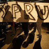 Anti-Troika protesters hold a "Hands off Cyprus" banner during a demonstration outside the EU offices in Nicosia in this March 24, 2013 file