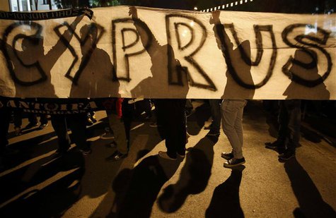 Anti-Troika protesters hold a "Hands off Cyprus" banner during a demonstration outside the EU offices in Nicosia in this March 24, 2013 file Anti-Troika protesters hold a "Hands off Cyprus" banner during a demonstration outside the EU offices in Nicosia in this March 24, 2013 file