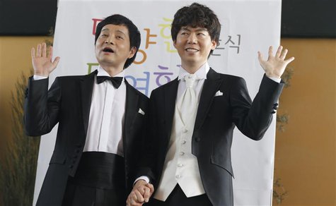 Gay South Korean film director Kim Jho Gwang-soo (L) and his partner Kim Seung-hwan pose during a news conference in Seoul May 15, 2013. REU Gay South Korean film director Kim Jho Gwang-soo (L) and his partner Kim Seung-hwan pose during a news conference in Seoul May 15, 2013. REU
