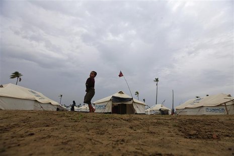 A girl from the Pauktaw township walks in a Rohingya internally displaced persons (IDP) camp outside Sittwe May 15, 2013. REUTERS/Soe Zeya T A girl from the Pauktaw township walks in a Rohingya internally displaced persons (IDP) camp outside Sittwe May 15, 2013. REUTERS/Soe Zeya T