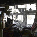 A member of the Free Syrian Army holds his rifle as he sits on a sofa in Deir al-Zor May 12, 2013. Picture taken May 12, 2013. REUTERS/Khali