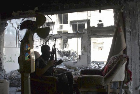 A member of the Free Syrian Army holds his rifle as he sits on a sofa in Deir al-Zor May 12, 2013. Picture taken May 12, 2013. REUTERS/Khali A member of the Free Syrian Army holds his rifle as he sits on a sofa in Deir al-Zor May 12, 2013. Picture taken May 12, 2013. REUTERS/Khali