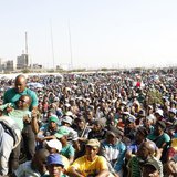 An unruly AMCU member (L) is removed from a gathering as other members are addressed by their leaders during a strike at Lonmin's Marikana p