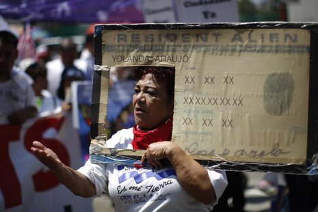 Rosa Ayala carries a Resident Alien placard during the International Workers Day and Immigration Reform March on May Day in Los Angeles, Cal Rosa Ayala carries a Resident Alien placard during the International Workers Day and Immigration Reform March on May Day in Los Angeles, Cal