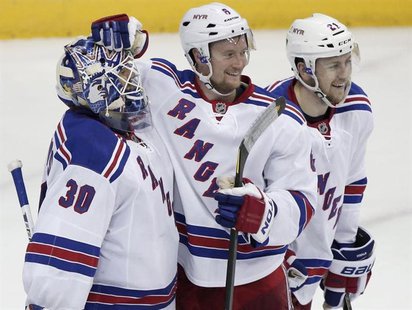 New York Rangers goalie Henrik Lundqvist (30) celebrates defeating the Washington Capitals with team mates Anton Stralman (6) and Derek Step New York Rangers goalie Henrik Lundqvist (30) celebrates defeating the Washington Capitals with team mates Anton Stralman (6) and Derek Step