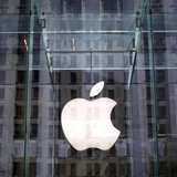 The Apple logo hangs inside the glass entrance to the Apple Store on 5th Avenue in New York City, April 4, 2013. REUTERS/Mike Segar