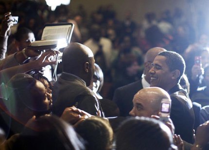 A churchgoer (L) tries to hand a Bible to US Democratic presidential candidate Barack Obama (R) to autograph as he greet worshippers followi A churchgoer (L) tries to hand a Bible to US Democratic presidential candidate Barack Obama (R) to autograph as he greet worshippers followi