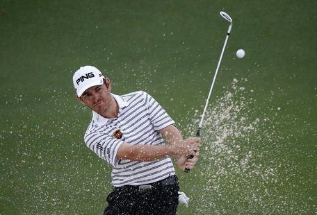 Louis Oosthuizen of South Africa hits from a sand trap on the second hole during second round play in the 2013 Masters golf tournament at th Louis Oosthuizen of South Africa hits from a sand trap on the second hole during second round play in the 2013 Masters golf tournament at th