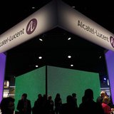 Visitors walk at the Alcatel-Lucent booth at the Mobile World Congress in Barcelona February 28, 2012. REUTERS/Albert Gea Visitors walk at the Alcatel-Lucent booth at the Mobile World Congress in Barcelona February 28, 2012. REUTERS/Albert Gea