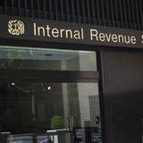 A woman walks out of the Internal Revenue Service building in New York in this May 13, 2013 photo. REUTERS/Shannon Stapleton