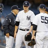 New York Yankees starting pitcher Phil Hughes heads to the dugout after being removed by Yankees manager Joe Girardi during the first inning New York Yankees starting pitcher Phil Hughes heads to the dugout after being removed by Yankees manager Joe Girardi during the first inning