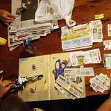 Katie Busker, 30, clips coupons as her son, Austin Spiker, 6, plays with Legos at the dinner table in Independence, Iowa July 5, 2011. TED S Katie Busker, 30, clips coupons as her son, Austin Spiker, 6, plays with Legos at the dinner table in Independence, Iowa July 5, 2011. TED S