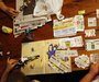 Katie Busker, 30, clips coupons as her son, Austin Spiker, 6, plays with Legos at the dinner table in Independence, Iowa July 5, 2011. TED S