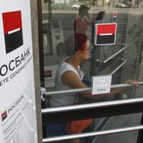 A woman walks out of an office of Rosbank in central Moscow, May 15, 2013. REUTERS/Maxim Shemetov