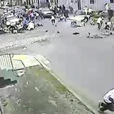 A still image taken from security camera video released by the New Orleans Police Department (NOPD) shows a gunman (bottom R) running away a