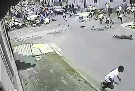 A still image taken from security camera video released by the New Orleans Police Department (NOPD) shows a gunman (bottom R) running away a A still image taken from security camera video released by the New Orleans Police Department (NOPD) shows a gunman (bottom R) running away a