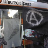 Students paint on the front of a Unicredit bank during a protest against government budget cuts in Milan December 12, 2012. REUTERS/Stringer Students paint on the front of a Unicredit bank during a protest against government budget cuts in Milan December 12, 2012. REUTERS/Stringer