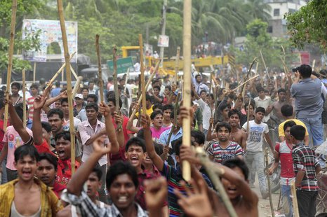 Garment workers shout slogans as they block a street during a protest to demand capital punishment for those responsible for the collapse of Garment workers shout slogans as they block a street during a protest to demand capital punishment for those responsible for the collapse of