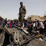 An Iraqi soldier steps over wreckage of a car bomb at the site of a car bomb attack in Baghdad's Sadr City May 16, 2013. REUTERS/Mohammed Am
