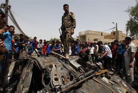 An Iraqi soldier steps over wreckage of a car bomb at the site of a car bomb attack in Baghdad's Sadr City May 16, 2013. REUTERS/Mohammed Am An Iraqi soldier steps over wreckage of a car bomb at the site of a car bomb attack in Baghdad's Sadr City May 16, 2013. REUTERS/Mohammed Am