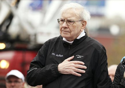 Berkshire Hathaway chairman Warren Buffett holds his hand over his heart during the singing of the national anthem, at the start of a 5km ra Berkshire Hathaway chairman Warren Buffett holds his hand over his heart during the singing of the national anthem, at the start of a 5km ra