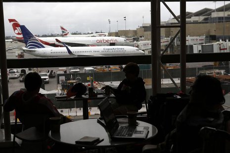 Passengers wait for their flights in the Tom Bradley International Terminal at Los Angeles International Airport (LAX), in Los Angeles, Cali Passengers wait for their flights in the Tom Bradley International Terminal at Los Angeles International Airport (LAX), in Los Angeles, Cali