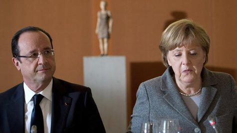 German Chancellor Angela Merkel (R) and French President Francois Hollande arrive for a dinner with representatives of the European Round Ta German Chancellor Angela Merkel (R) and French President Francois Hollande arrive for a dinner with representatives of the European Round Ta